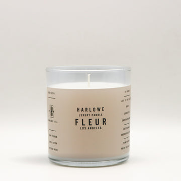 Harlowe Luxury Candle with Fleur label on a beige background