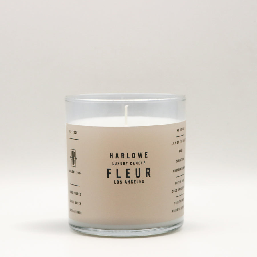 Harlowe Luxury Candle with Fleur label on a beige background
