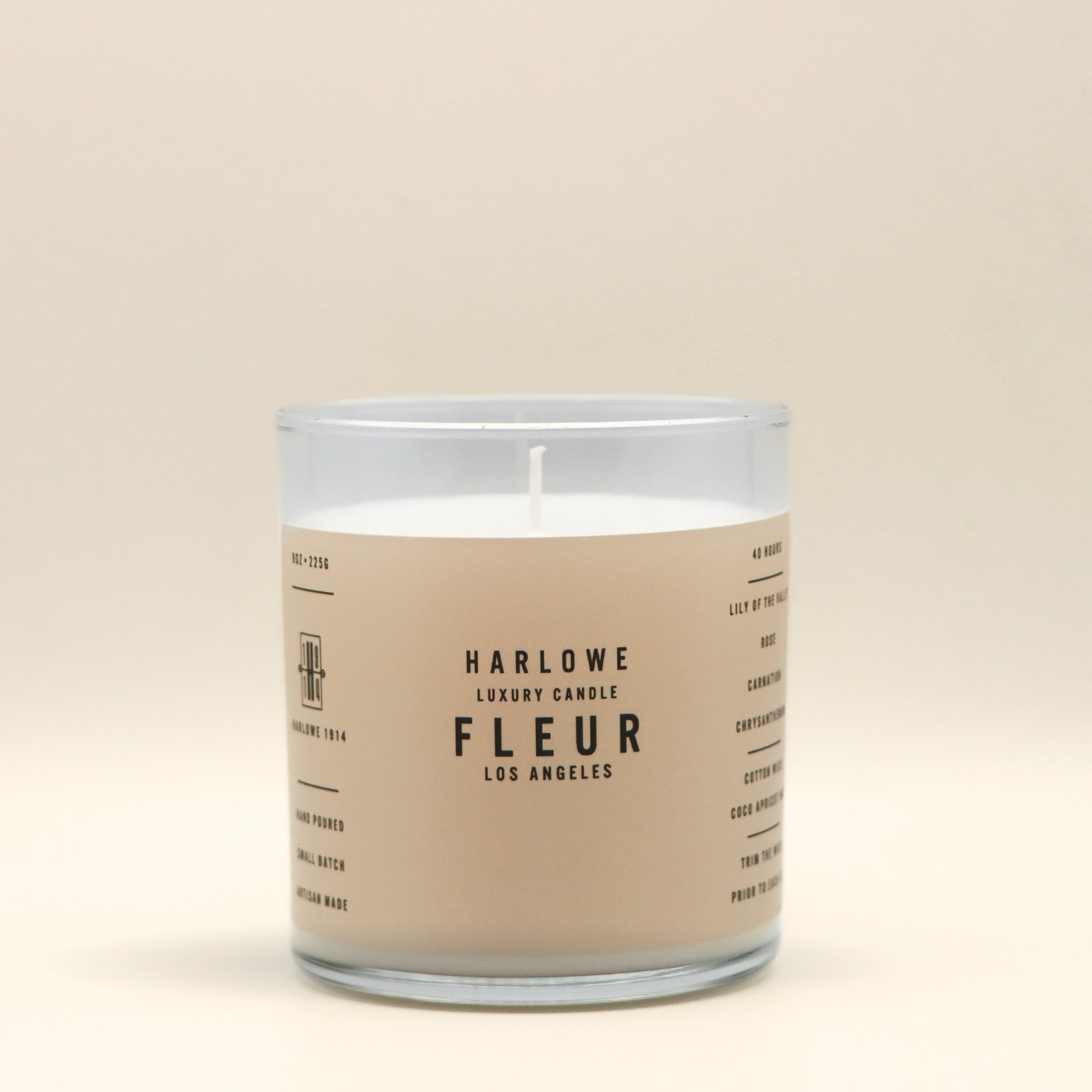 Harlowe Fleur Candle with a beige label on a beige background