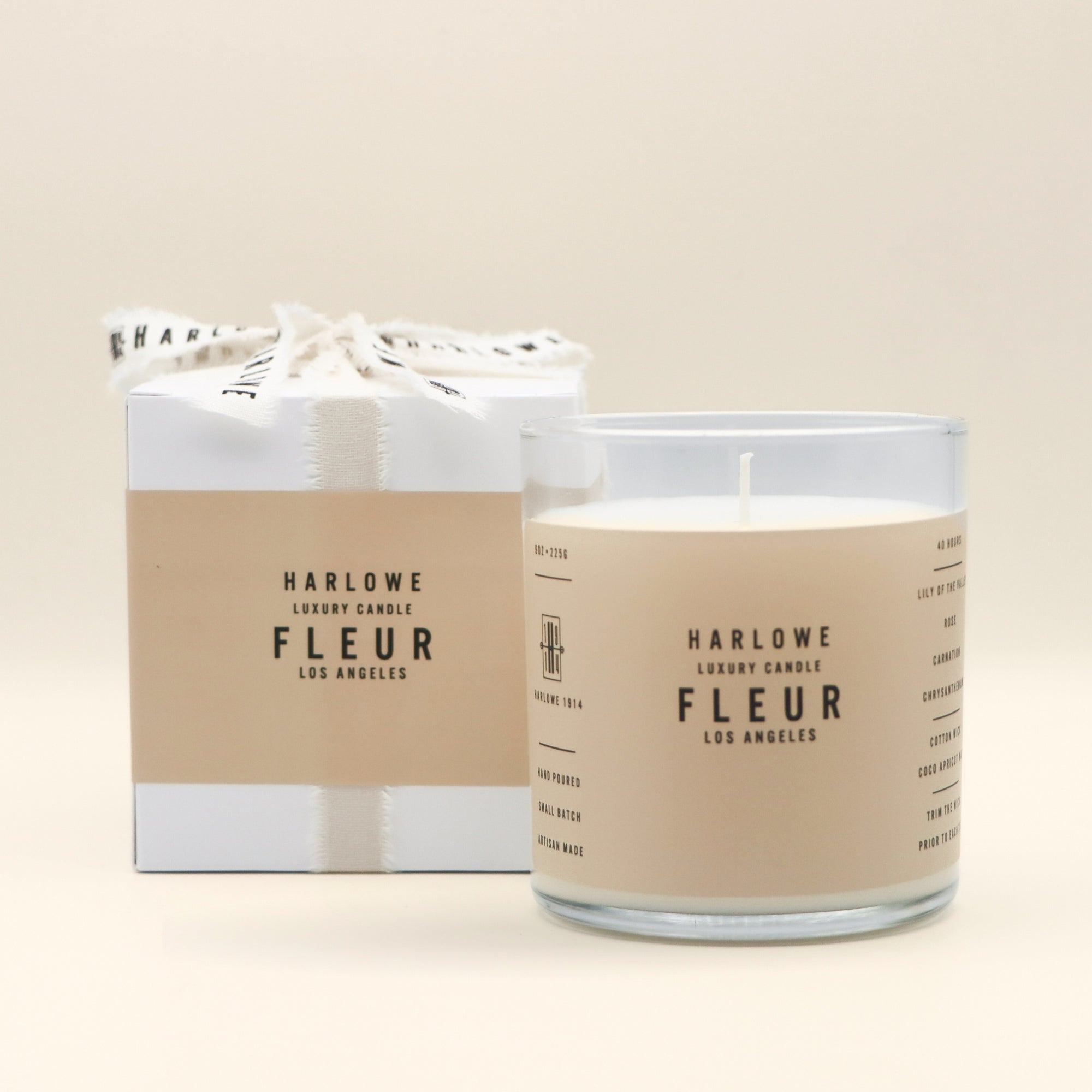 Harlowe Luxury Fleur Candle with packaging on a beige background