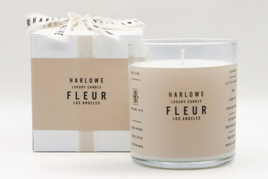 Harlowe Luxury Candle Fleur with candle and box on a light gray background
