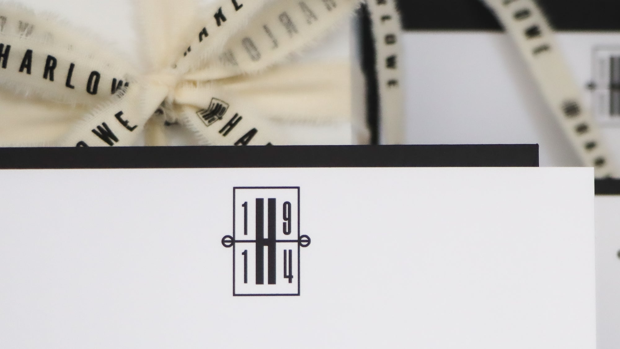 Product with 'Harlow' branding and a decorative bow on a white background.