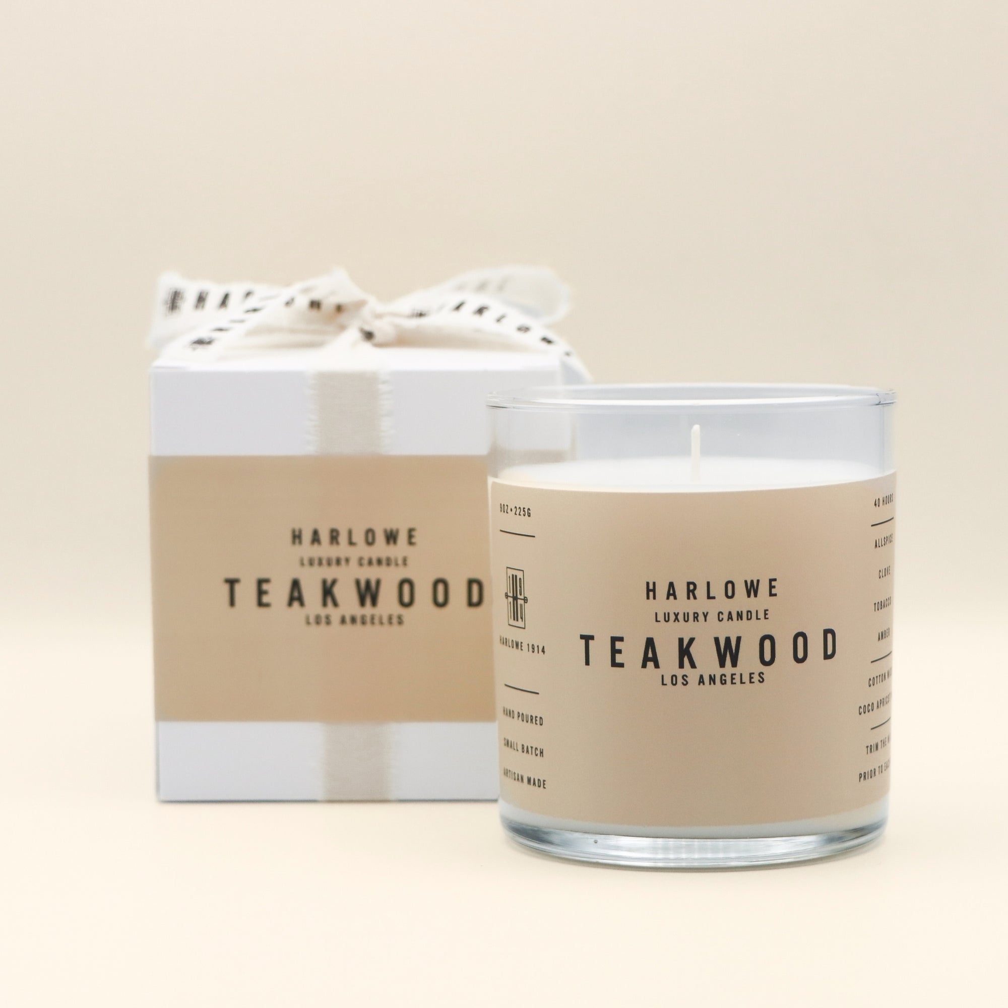 Harlowe Teakwood candle and packaging on a beige background