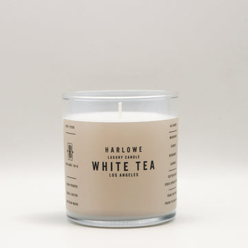 Harlowe Luxury Candle with White Tea label on a beige background