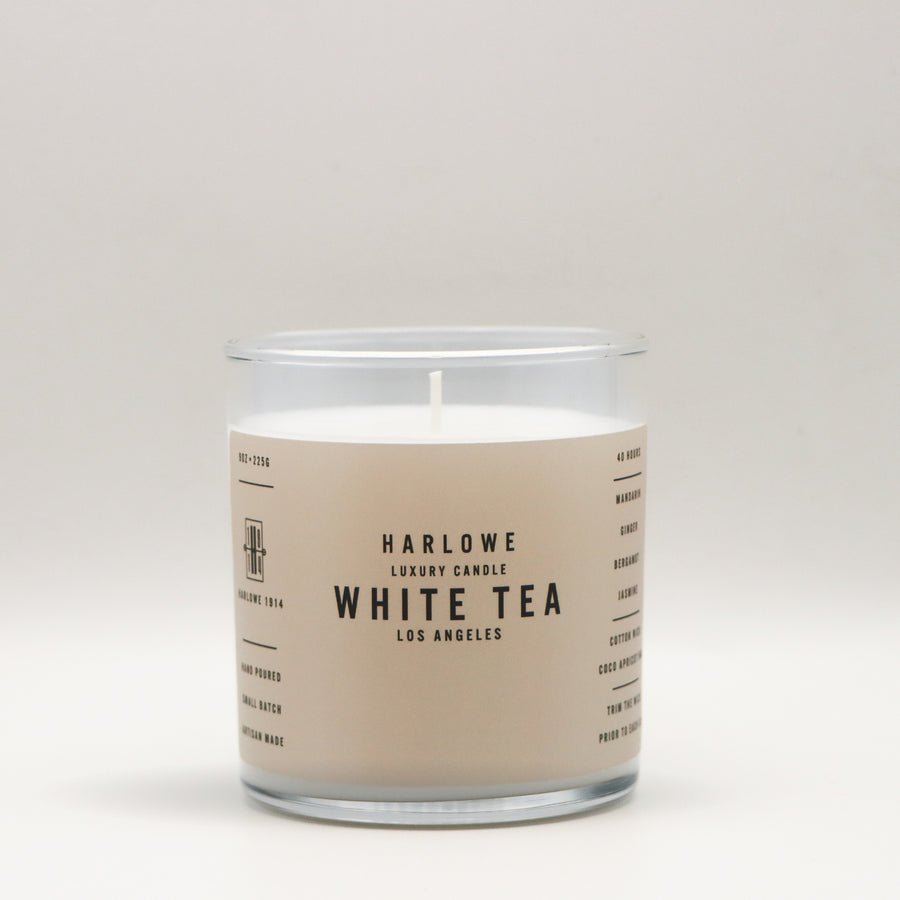 Harlowe Luxury Candle with White Tea label on a beige background