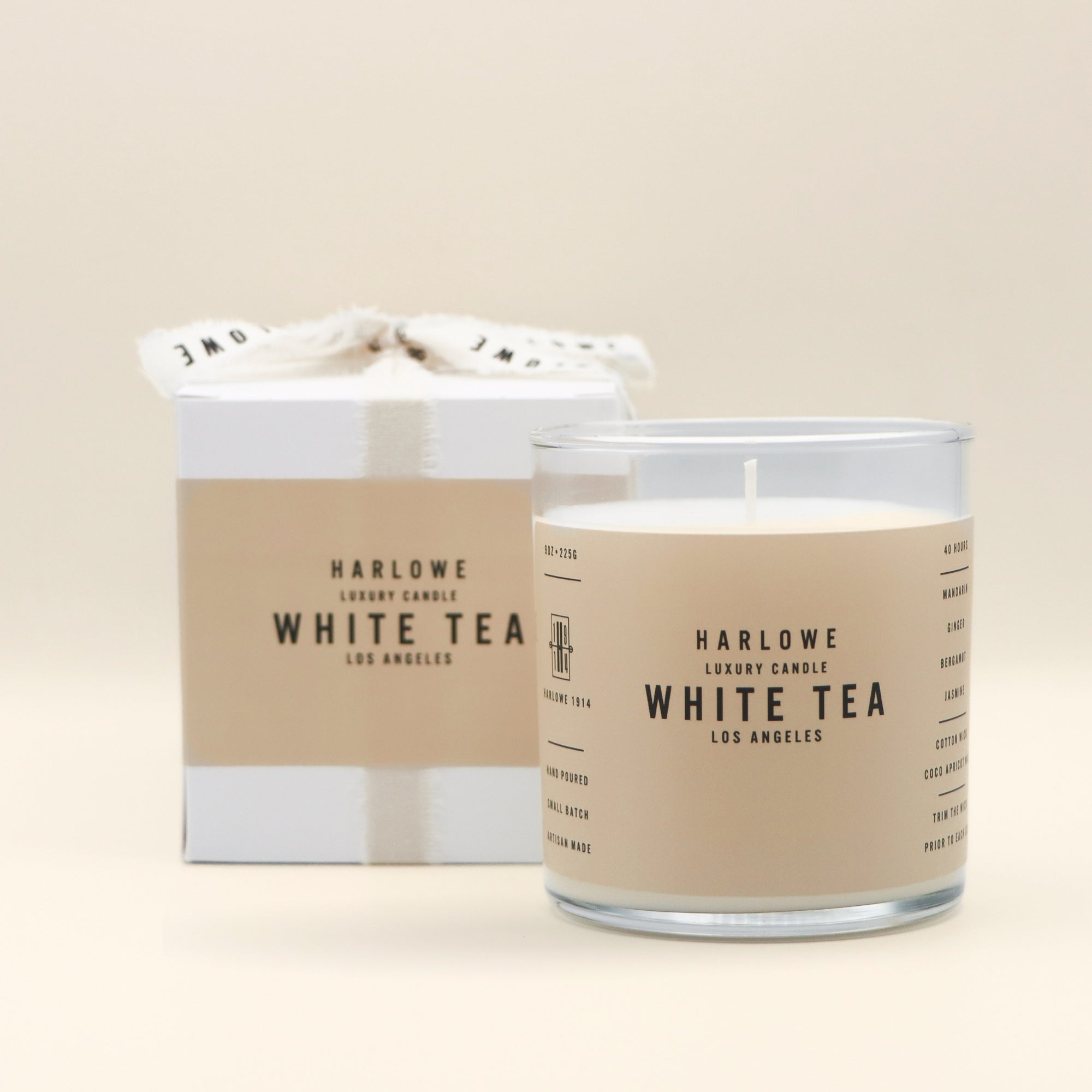 Harlowe White Tea candle with packaging on a beige background